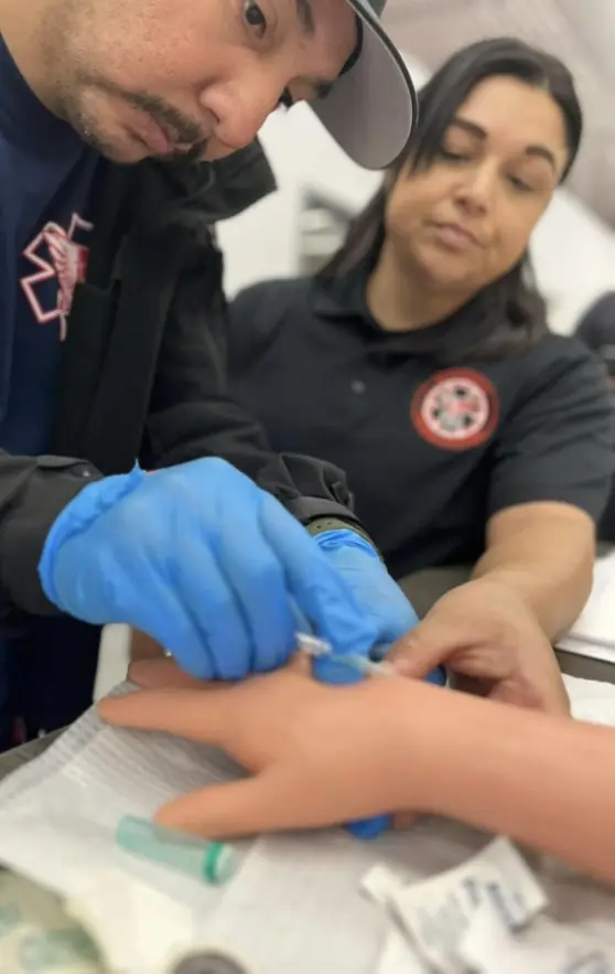 Elite Medical Training Solutions students practicing hands-on IV training techniques