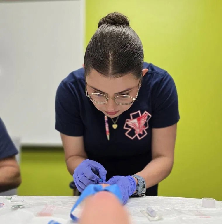 EMTS Advanced EMT student starting an IV on a training arm
